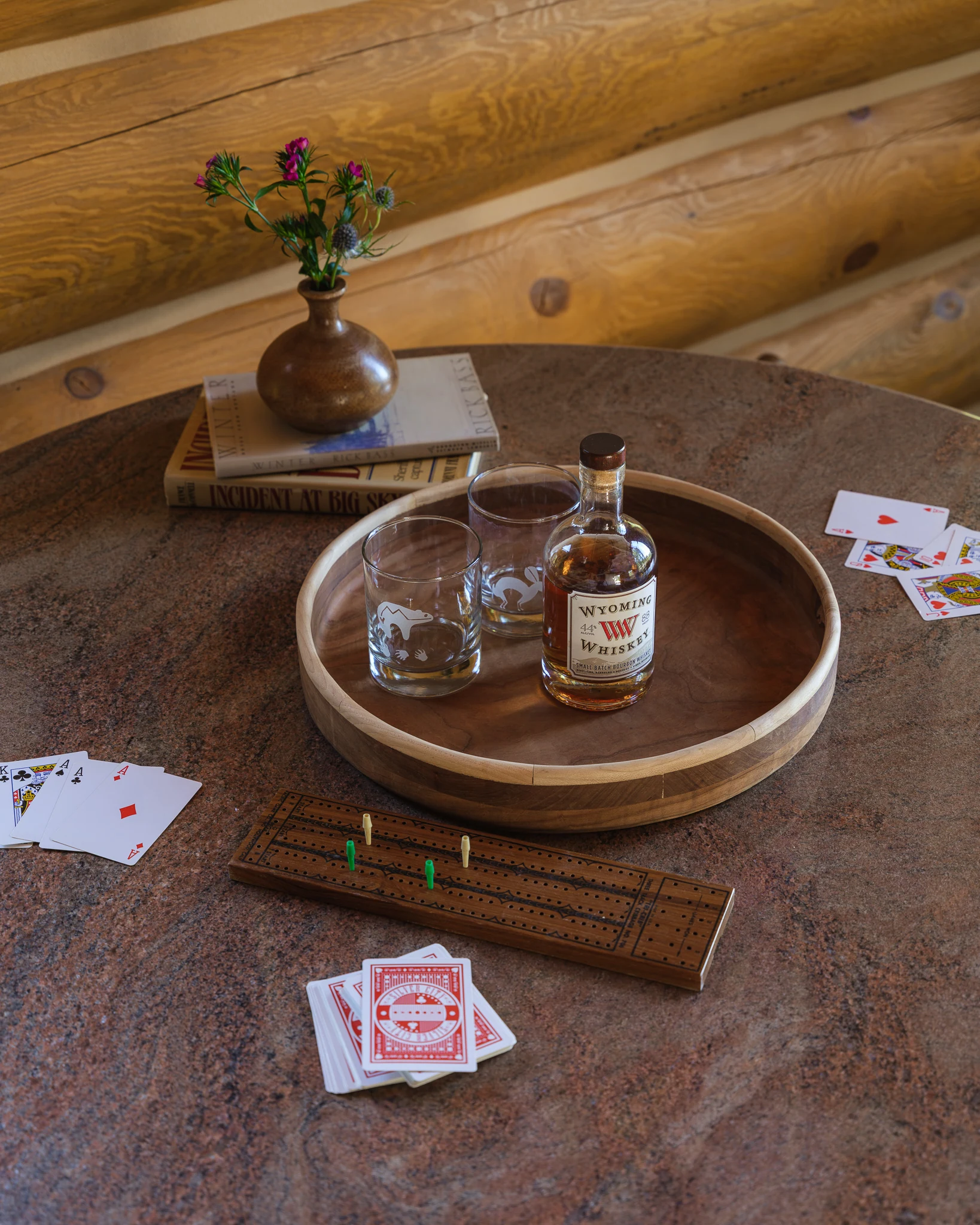 Overhead detail of a cribbage board, whiskey, and playing cards — interior design photography Livingston Montana, Bear Canyon Ranch